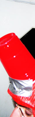 This scene is a combination of a friend named Peter, a red, rubber wig that he unwillingly received, some duct-tape, three red, plastic cups, and, um... another friend's house.
