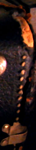 The scuffed top of my Trombone case. Black leatherish covering with silver bits holding it all together.