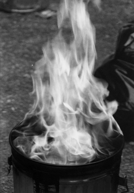 A currently flaming trashcan used to cool Raku pottery