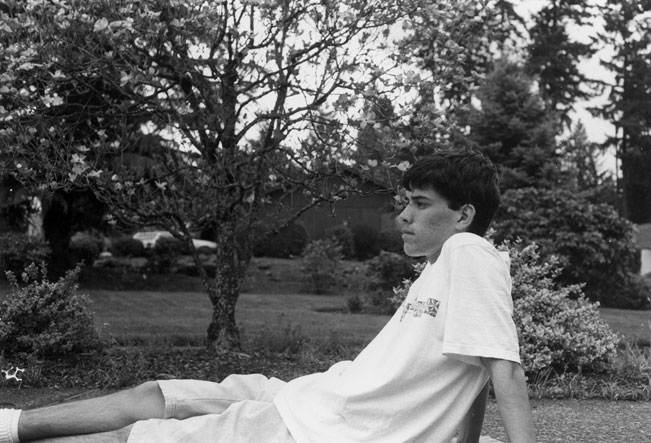 Me sitting on the driveway beside the yard